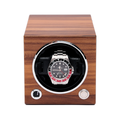 Front view of a wooden single watch winder with round opening and a stainless steel watch inside.