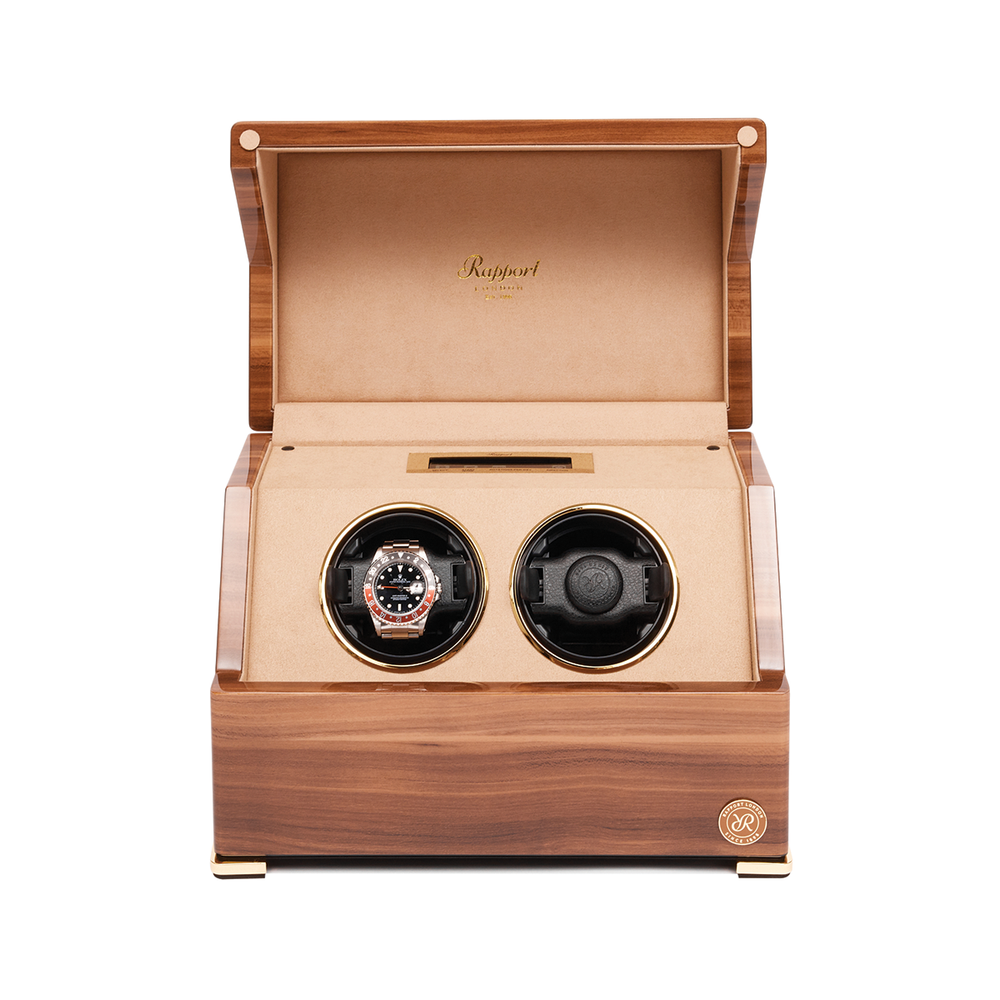 Front view of the wooden two-slot watch winder showing gold toned watch in left slot and black dial watch in right slot