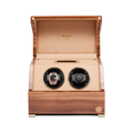 Front view of the wooden two-slot watch winder showing gold toned watch in left slot and black dial watch in right slot