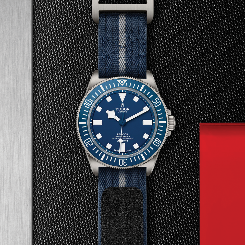 Tudor Pelagos FXD 42mm titanium watch with blue dial and bezel on a striped blue fabric strap