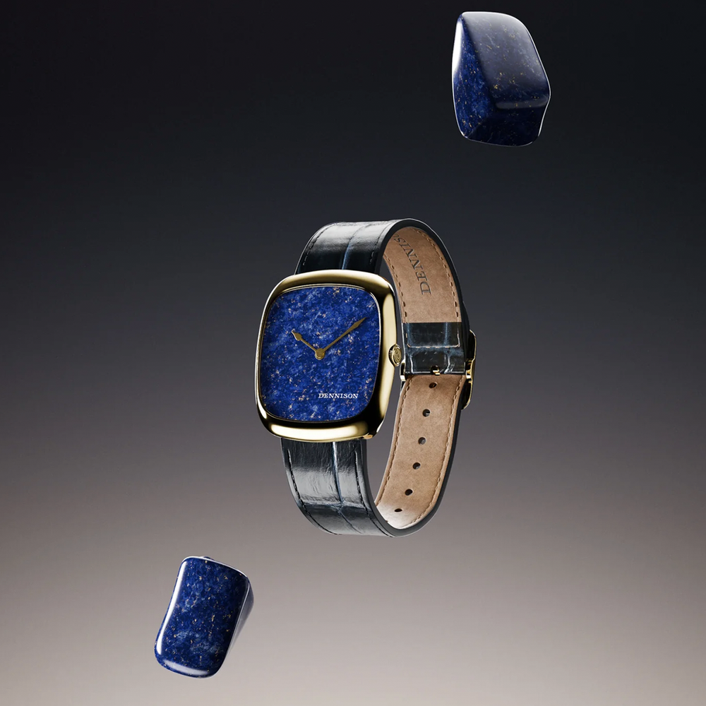 Blue lapis lazuli dial in a gold square watch case on a black leather strap against a dark gradient.