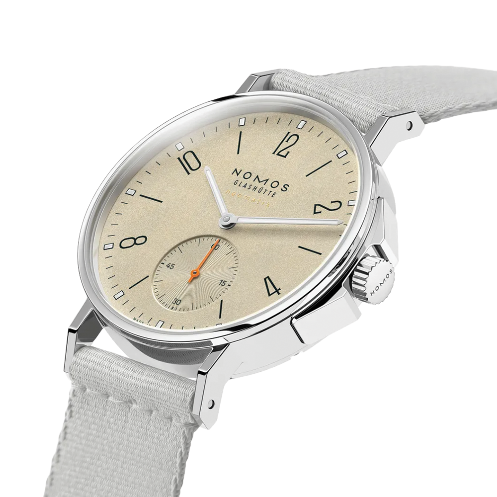 Nomos Ahoi Neomatik Sand beige dial watch with stainless steel case on light fabric strap, angled view