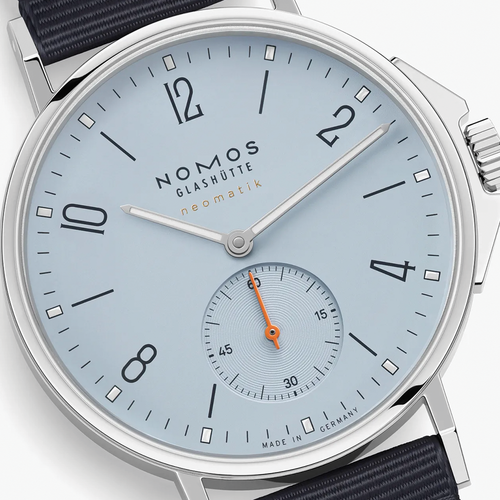 Close-up of the light blue dial with orange seconds hand and subdial on Nomos Ahoi Neomatik Sky 36mm.