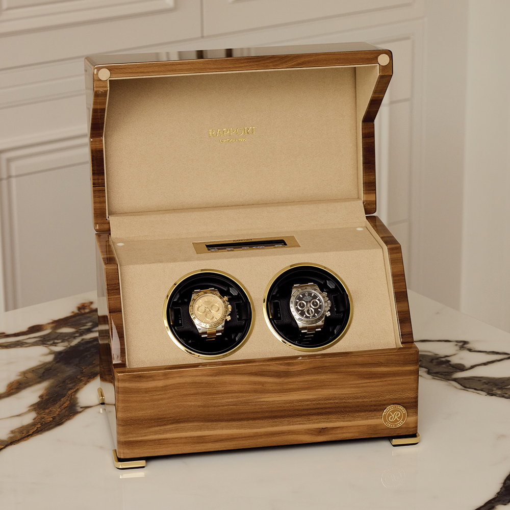 Open wood Perpetua Duo watch winder displaying two watches inside beige interior