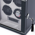 Close-up of interior four watch slots with a stainless steel watch in bottom-right slot inside the carbon fiber Formula Quad Watch Winder