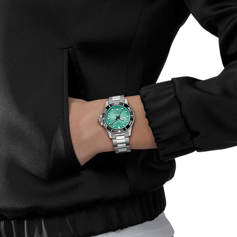 Wrist view of a turquoise dial Tissot Seastar 1000 Quartz 36mm on a stainless steel bracelet