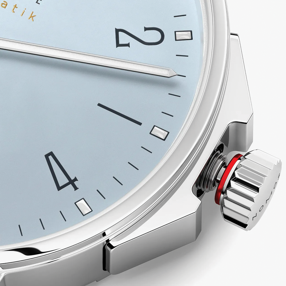 Close up of Ahoi Neomatik Sky blue dial with slim silver hands and black index markers
