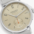 Close-up of beige dial with orange seconds hand from Nomos Ahoi Neomatik Sand on fabric strap