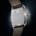 Back view of ALD Dual Time watch with Dennison engraving on the caseback and tan leather strap