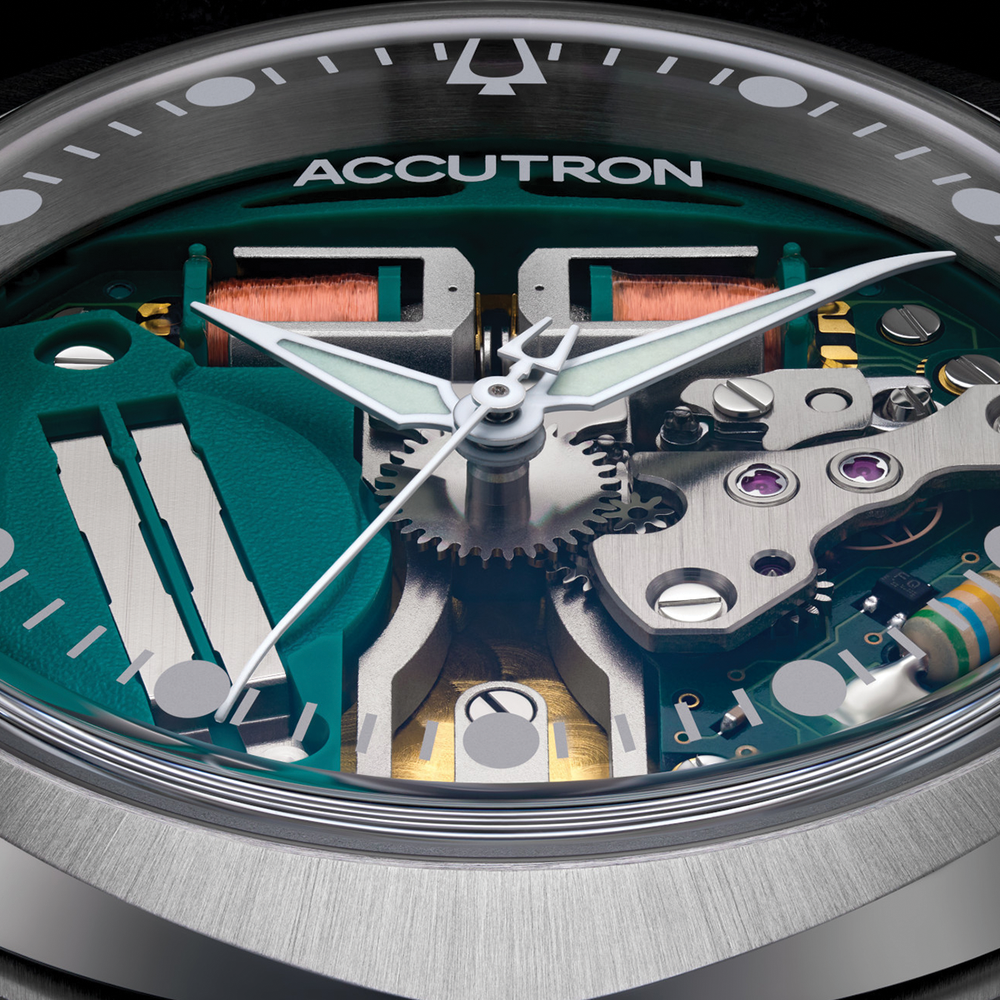 Macro view of Alpha 314 33mm movement with gears and teal components under a brushed steel bezel