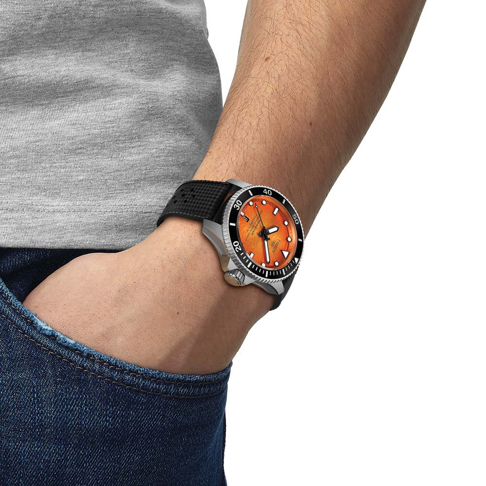 Wrist shot of Tissot Seastar 2000 orange dial diver watch on black rubber strap