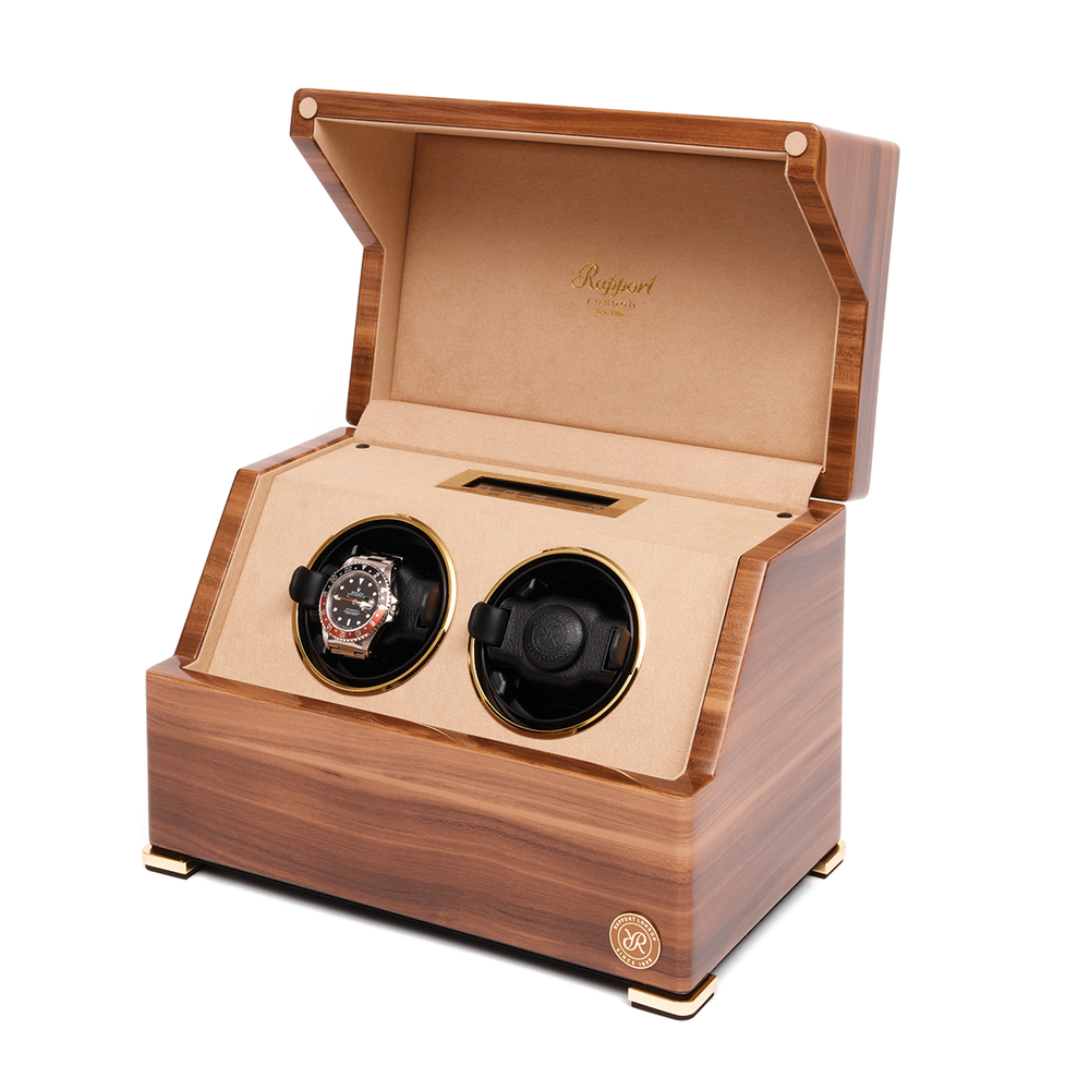 Open wooden two-slot watch winder with a silver sports watch in the left slot and the right slot empty