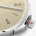 Close-up of crown and case on Ahoi Neomatik Sand with red crown gasket and polished stainless steel