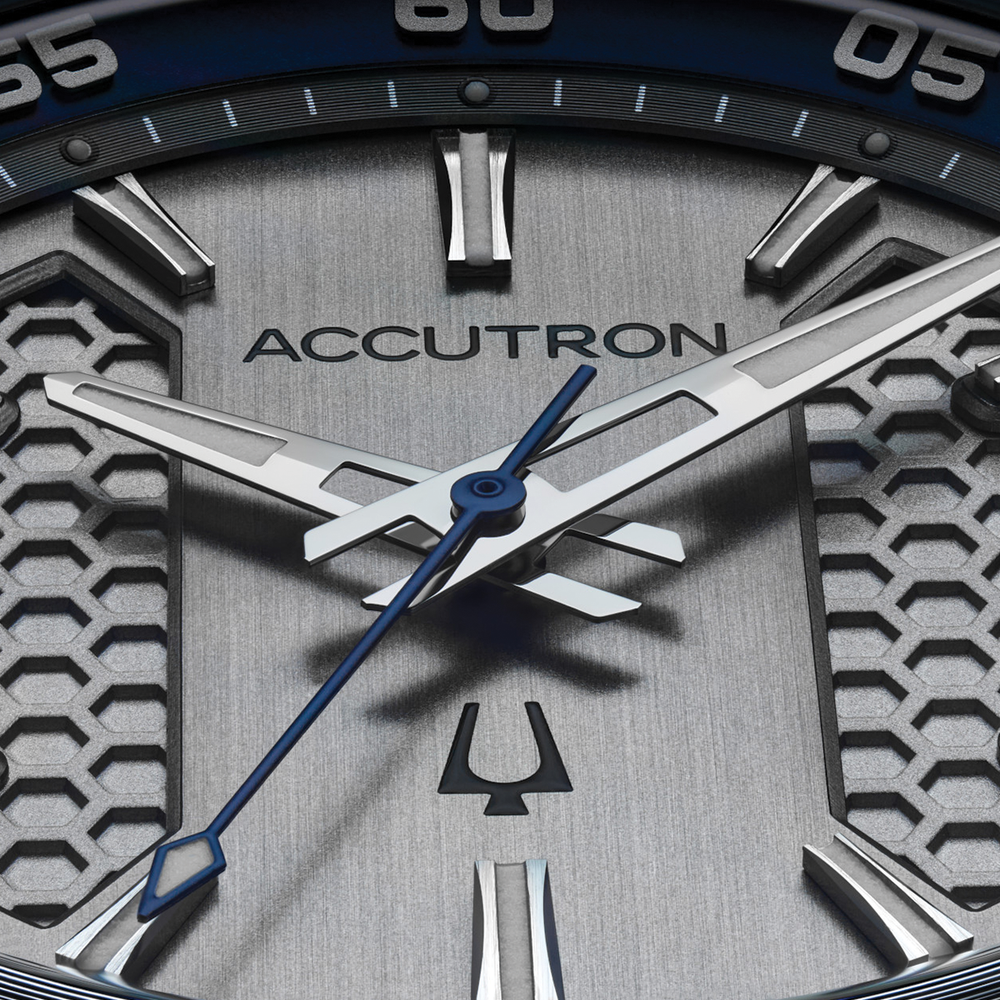 Close up of Elevation 39mm grey dial Accutron watch with blue bezel and silver hour markers.