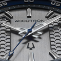 Close up of Elevation 39mm grey dial Accutron watch with blue bezel and silver hour markers.
