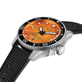 Close up of Tissot Seastar 2000 diver watch with orange dial, black bezel and silver case on a black rubber strap