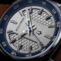 Close up of Elevation 39mm grey dial with honeycomb texture silver markers and blue second hand