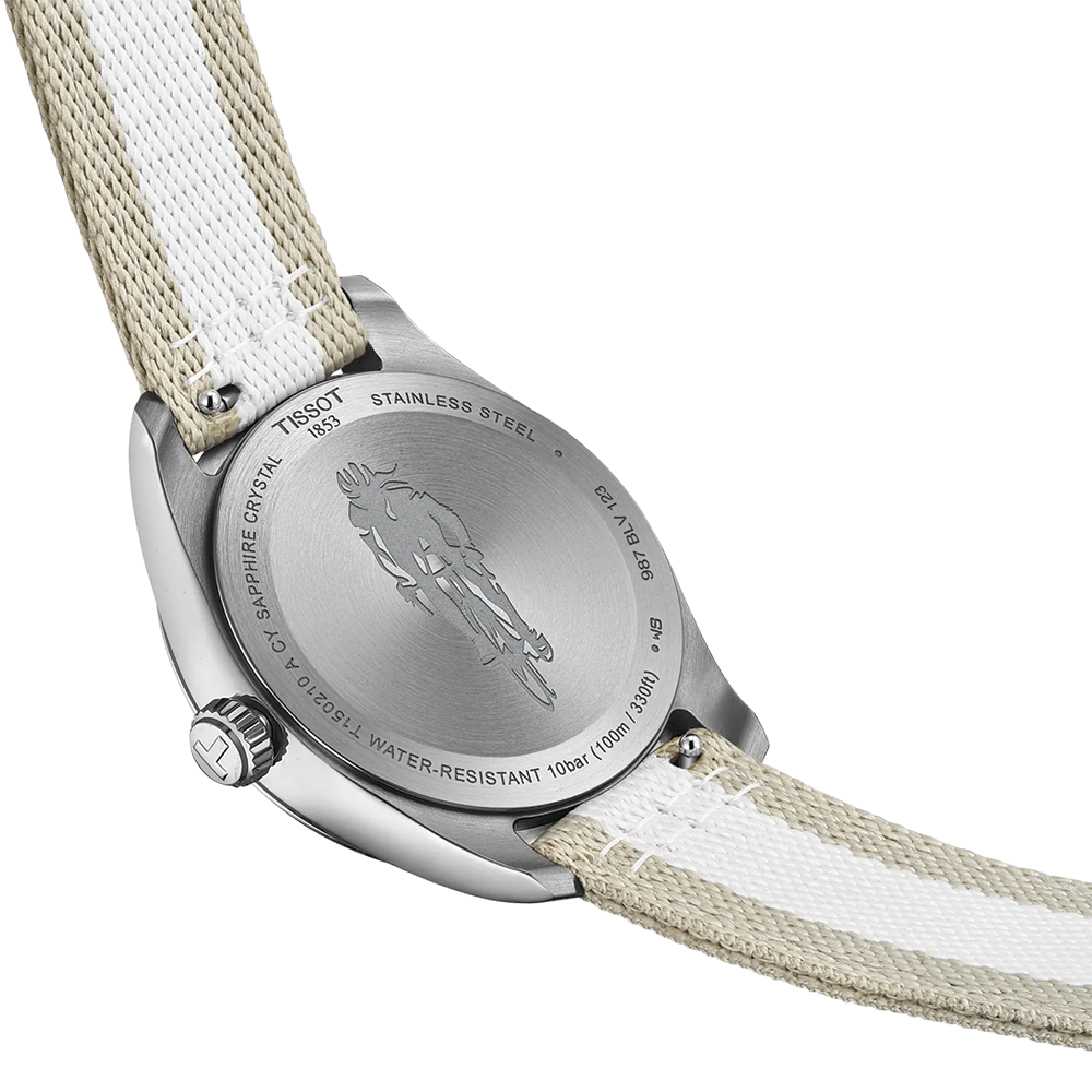 Back view of the Tissot watch showing a stainless steel case back with engraving and a beige white striped fabric strap.