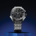 Horizon 41.5mm watch with black dial on brushed steel bracelet against a dark gradient background