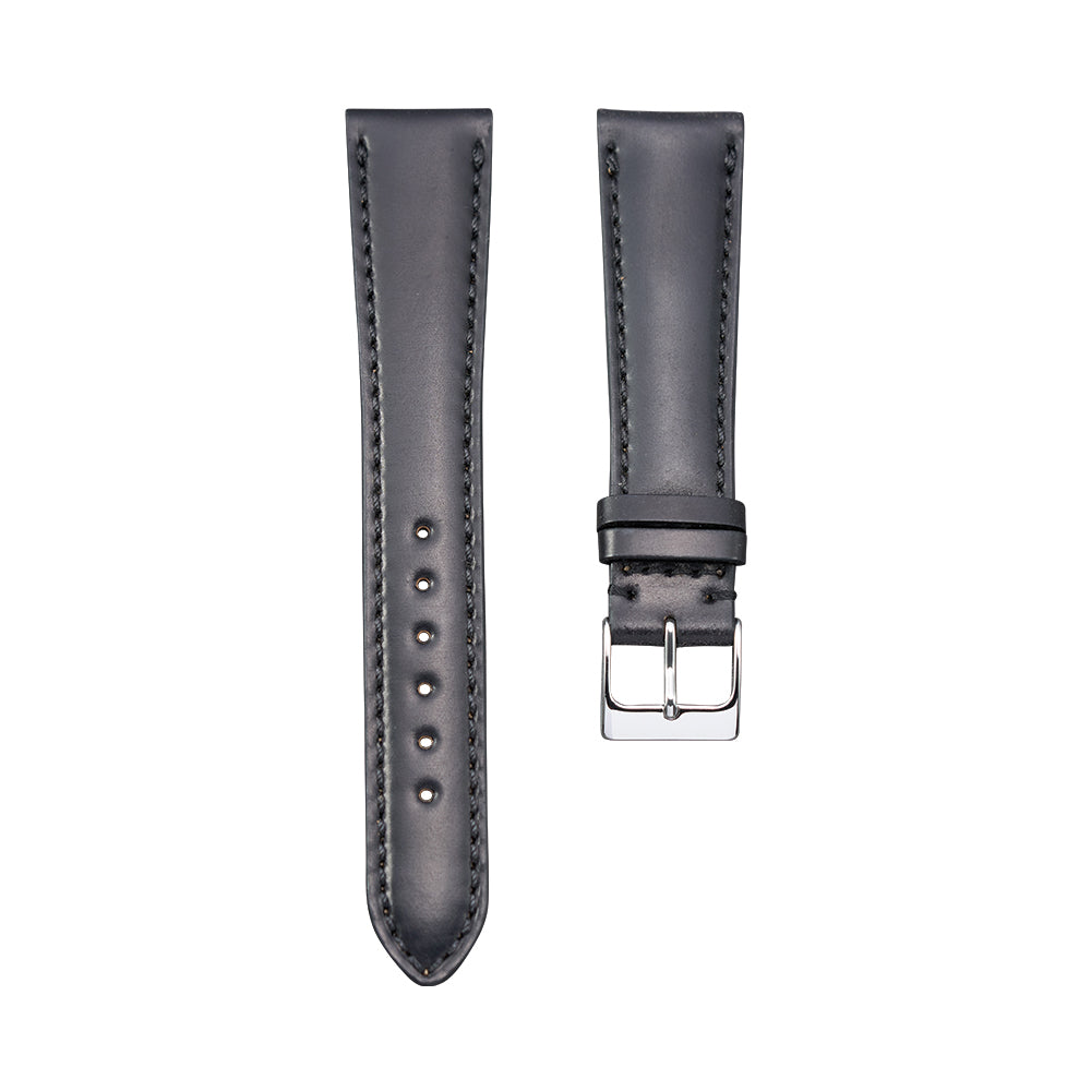 Two piece black Shell Cordovan leather watch strap set with punched holes on the longer piece and a silver buckle on the shorter piece