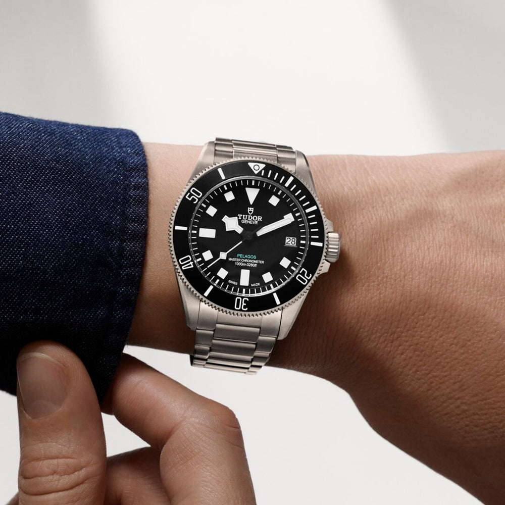 Pelagos Ultra Titanium 43mm watch on stainless steel bracelet worn on a forearm with a denim cuff