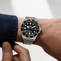 Pelagos Ultra Titanium 43mm watch on stainless steel bracelet worn on a forearm with a denim cuff