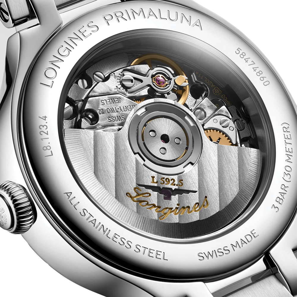 Close up of Primaluna movement through the transparent case back with engravings and gears.