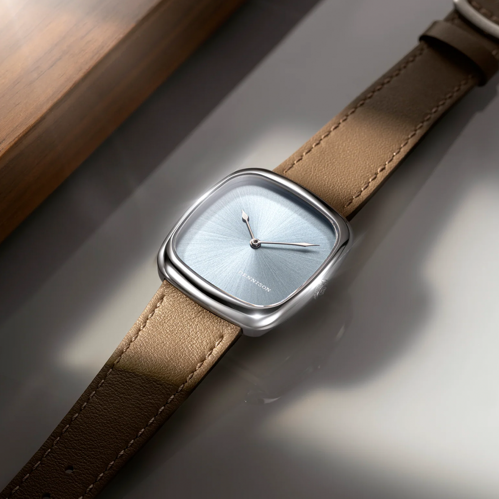 Close up of ALD Time Only Sunray Ice Blue steel watch with blue sunburst dial and brown leather strap